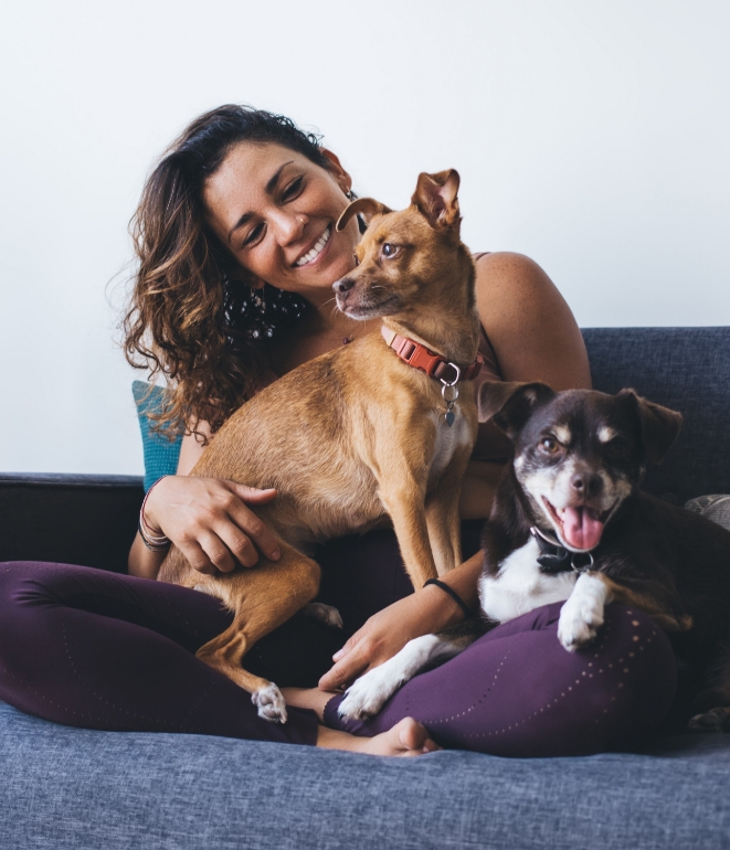 Woman and two dogs relaxing after air conditioning repair in Huntertown, IN.